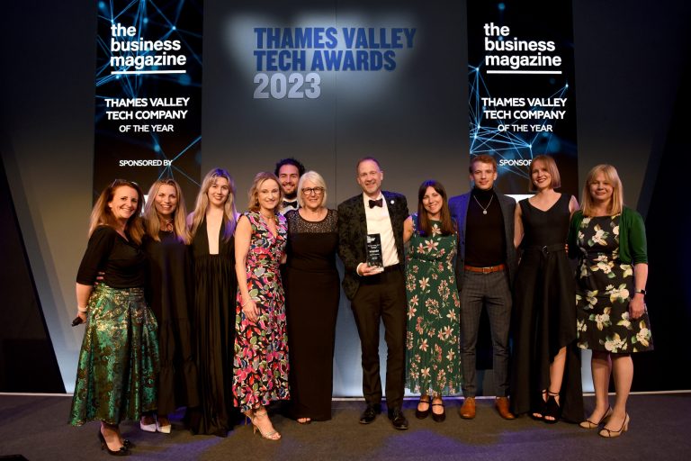 The Team on stage at the Thames Valley Awards, after winning, holding the trophy for Company of the Year.
